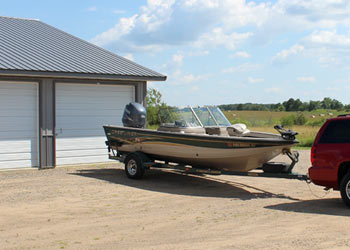 Fishing boat in front of a storage unit at Strack's Self Storage in Randall, MN