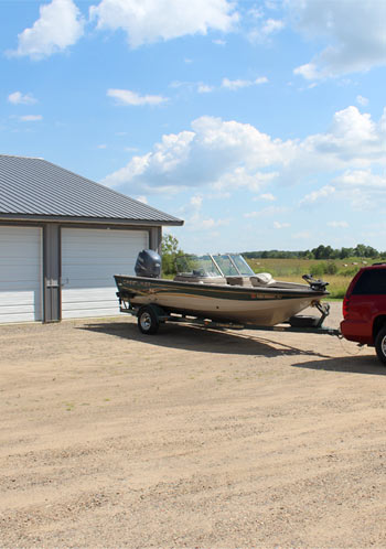 Fishing boat in front of a storage unit at Strack's Self Storage in Randall, MN